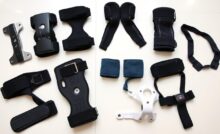 Various types of knee braces laid out showing different designs for specific conditions